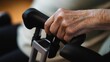 © Oksana - Close-up of elderly patient’s hand firmly gripping a rehabilitation device handle, showcasing strength, determination, and focus during physical therapy sessions in a clinical setting.