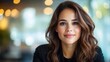 © Vuvimages - With a captivating smile and approachable demeanor, this professional woman exudes warmth and confidence amidst a softly blurred office background conveying success.