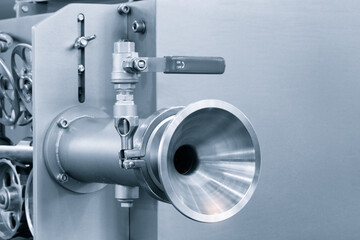 Poster - Dairy machine cooling radiator with a row of stainless steel metal pipes with silver trim. The pipes are connected to each other and appear to be part of a larger system