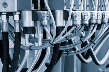 Poster - Close-up of precise industrial equipment with pneumatic components:  plastic tubes with connectors. Industrial concept background.