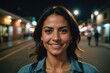 © ThomasLENNE - Close portrait of a smiling 40s Costa Rican woman looking at the camera, Costa Rican city outdoors at night blurred background