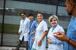 © Marko Geber - Happy medical team socializing outside hospital during break