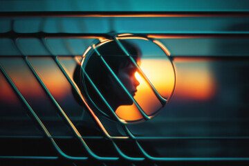 Fototapete - Profile Silhouette Against Vibrant Sunset Reflections, Through Geometric Structures