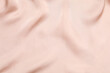 © Sunlight - Beige silk satin. Shiny smooth fabric. Soft folds. Luxury background with space for design. Flat table, top view