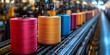 © Dmitry - Colorful spools of thread occupy the production line in a textile factory, showcasing a blend of artistry and industry in a vibrant work environment