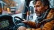 © Dennis - Truck driver using GPS navigation system to plan route and destination in the cab.