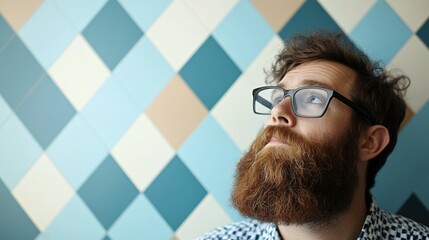 Wall Mural - Man with beard and glasses using a desktop computer in a modern office, serious expression, bright lighting and clean work environment