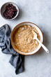 © The Picture Pantry - An overhead view of a mixing bowl filled with batter and a bowl of chopped dark chocolate, accompanied by a gray linen cloth.