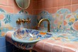 © Razia - Artistic washroom with hand-painted ceramic tiles, a sculptural sink, and unique brass faucets.