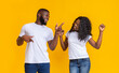 © Prostock-studio - Attractive african american couple dancing and looking at each other, yellow studio background