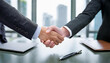 © H.J___96 - A photo highlighting a business handshake in the background of the office