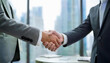 © H.J___96 - A photo highlighting a business handshake in the background of the office