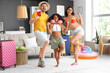 © Pixel-Shot - Happy family with passport and suitcases at home. Travel concept