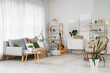 © Pixel-Shot - Interior of light living room with sofa, armchair and plants