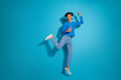© deagreez - Full size photo of pretty young male listen music dance winning wear trendy outfit isolated on blue color background
