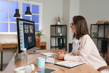 Sticker - Young businesswoman video chatting in office at night