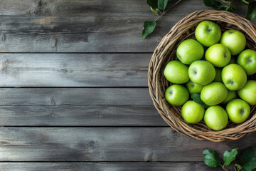 A basket of green apples on a wooden surface, showcasing fresh produce.