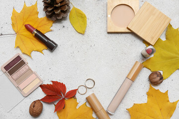 Canvas Print - Frame made of decorative cosmetics, walnuts and yellow fallen leaves on light background