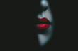 © jr-art - A woman's face is shown in a black background with her lips painted red