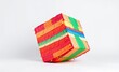 © Global Perspectives - Colorful mexican pinata shaped like a cube on a white backdrop birthday backdrop Ultra realistic Photorealistic Deco era