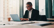 © K.A./peopleimages.com - Office building, Japanese businessman and laptop with typing, documents or project management as ceo. Mature, male person and paperwork on tech for online, connection and review in company or agency