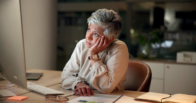 frustrated, mature woman and night with computer for deadline, pressure or difficult task at office.