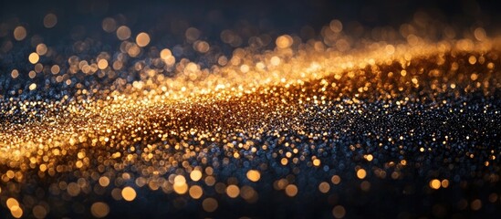 Wall Mural - glittering gold sparkles on a black background for festive occasions with ample empty space for crea