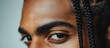 © AImmersive Imagery - Male portrait with braided hairstyle and pensive expression highlighting intricate braids and captivating gaze in a close-up shot