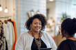 © Inspiraciones - Latina female business owner, overweight, curly hair, casual style, smiling.