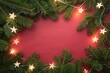 © Yuwadee - A Festive Holiday Frame of Evergreen Branches and Star Lights on Red