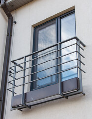 Wall Mural - A window with a metal railing and a window box