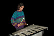 © AlvaroRT - Young jazz musician playing the vibraphone in his private rehearsal room. Black background.