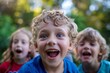 © Enrique - Close-up portrait of a cute little boy with blond curly hair and bright blue eyes in the park on a sunny day