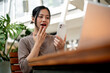 © bongkarn - An amazed, excited Asian woman surprised by an unexpected good news through a message on her phone.