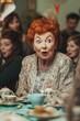 © RaptorWoman - An elderly woman with vibrant red hair shows a surprised expression during a lively tea party gathering with friends.
