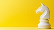 © Alexandr - A knight chess piece stands out against a bright yellow background, embodying strategy and conflict in a sleek, minimalist design.
