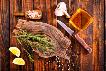 Sticker - Rosemary sprig on a wooden kitchen table.