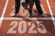 © Pcess609 - Starting to the new year 2025. woman preparing to start on an athletics track engraved with the year 2025. idea for planning, goals and New Year's resolutions.Adopting Success in 2025 for New Life.