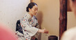 © peopleimages.com - Japanese woman, tea ceremony and preparation for matcha drink, cultural hospitality or heritage in chashitsu. Traditional ritual, person and beverage process for guests with custom practice in kimono