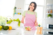 © deagreez - Charming young woman girl in apron preparing a fresh meal in bright kitchen