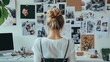 © Galib - A woman stands in front of a wall of inspiration boards in a home office.
