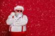 © deagreez - Photo of minded old man ponder december preparation finger chin wear santa hat costume isolated red color background