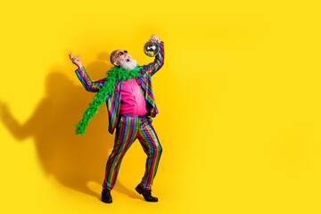 Canvas Print - Full size photo of excited old man showman hold discoball dance wear glamour striped bright clothes boa sunglass isolated yellow background