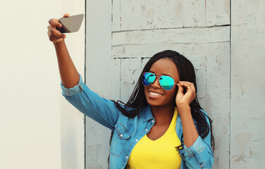 Wall Mural - Joyful happy young woman laughs taking selfie with phone, modern cheerful girl posing in casual