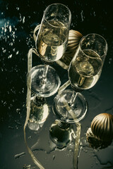 Wall Mural - two champagne glasses reflecting in glass New Year background