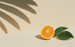 © praewpailyn - Juicy sliced orange with vibrant color and fresh green leaves, casting beautiful shadow on soft background, creating refreshing and inviting atmosphere