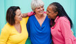 © DisobeyArt - Multiracial senior women having fun hugging together outdoor - Joyful 50's lifestyle, diversity and friendship concept - Main focus on african woman face