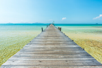 Wall Mural - long wooden bridge go to the sea in beautiful tropical island, thailand.