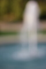Wall Mural - a dreamy view of a water fountain spounting in the park.