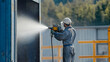 © HQAsset - Industrial Worker Spray Painting Metal Surface Outdoors,  Protective Gear,  Precise Application,  Efficient Technique
